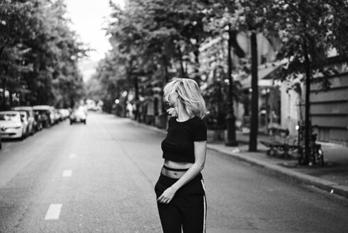 woman standing in the middle of the road