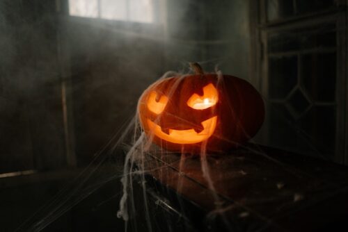 jack-o-lantern covered in cobwebs