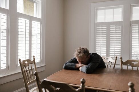 man with head down on table
